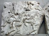British Museum Top 20 04-1 Elgin Marbles Block 37 4. Parthenon Horsemen block number 37 � Athens Parthenon, 447-432BC. The Elgin Marbles refers to the collection of sculptures from the Parthenon acquired by Lord Elgin between 1801 and 1805. The Parthenon was built as a temple to Athena on the Acropolis of Athens and was decorated with marble sculptures representing scenes from Athenian cult and mythology. This block from the north frieze shows three horsemen holding the reins of their galloping horses tightly in both hands. The first at the left wears a short chiton, chlamys and sandals, the second a double-belted sleeved chiton and sandals, whereas the body of the third at the join of the two blocks is badly damaged.